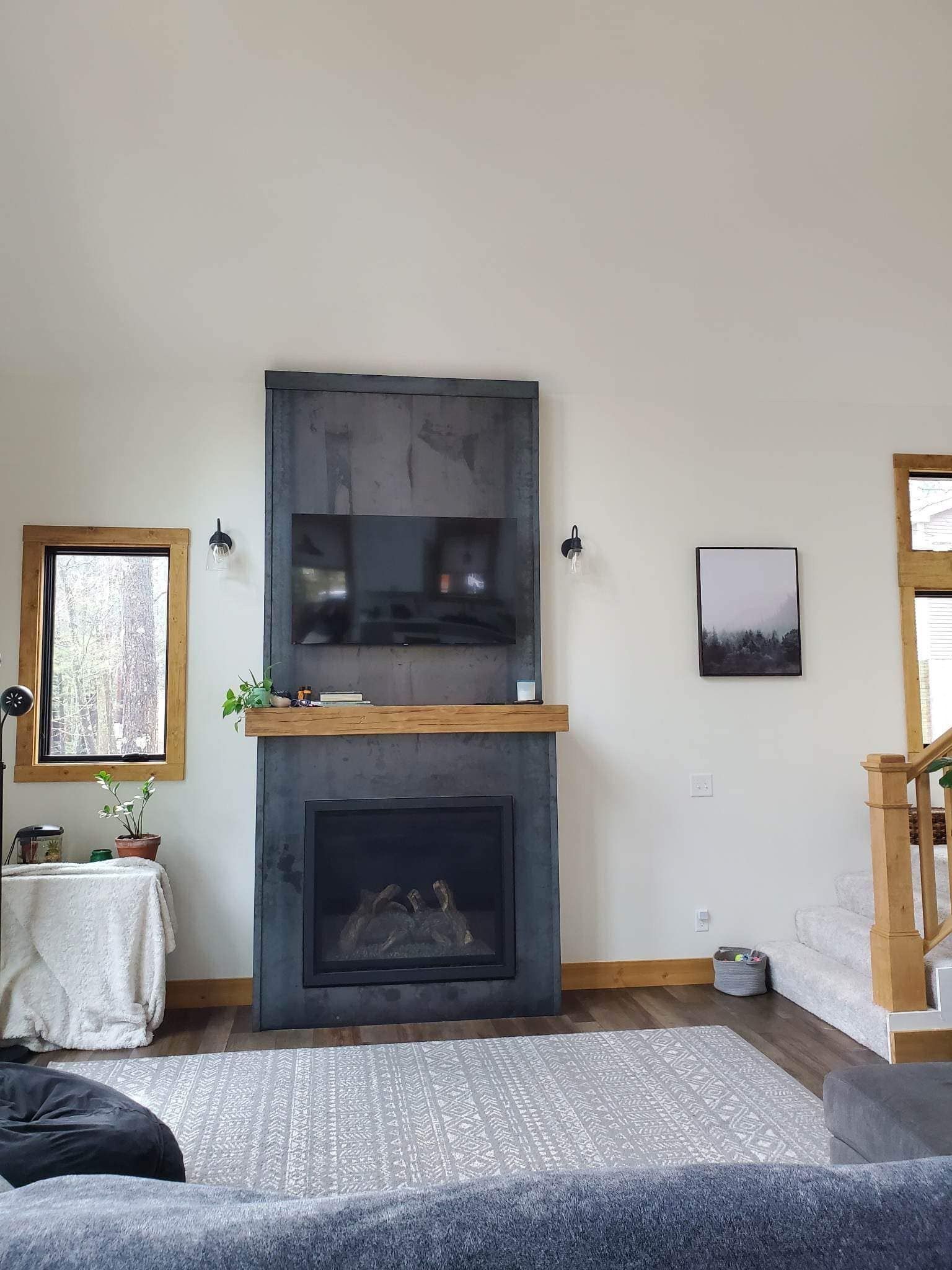 Custom hand-forged steel fireplace installation in Northern Michigan home
