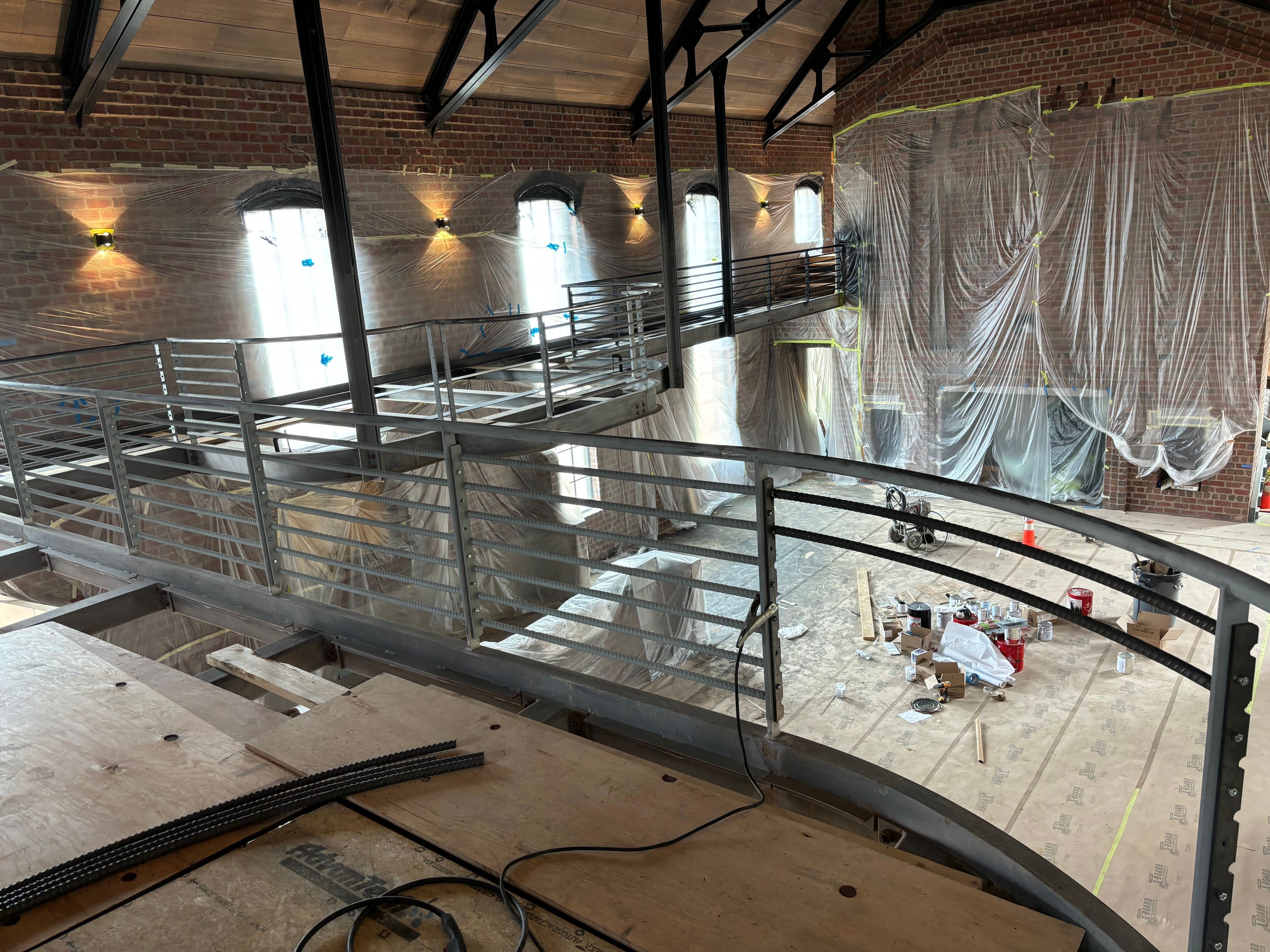 Traditional hot-riveted steel joinery on a custom barn build